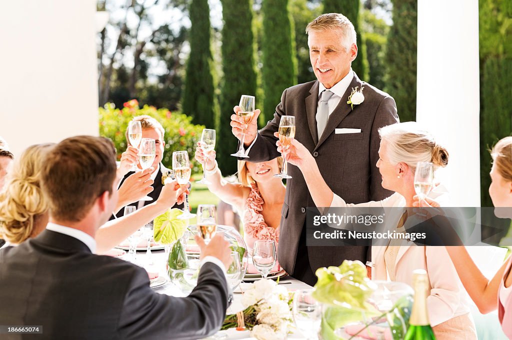 Father Of The Bride Toasting Champagne At Wedding