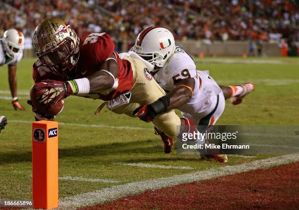 James Wilder Jr. #32 of the Florida State Seminoles dives for a touchdown during a game against the Miami Hurricanes at Doak Campbell Stadium on...