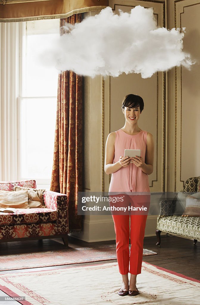 Smiling woman in living room with cloud above head