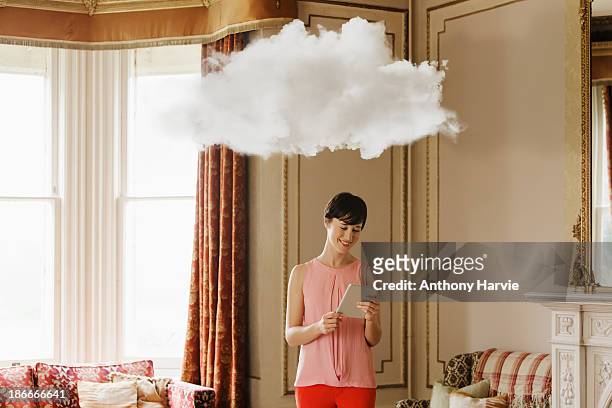 woman in living room with cloud above head - sicherungskopie stock-fotos und bilder