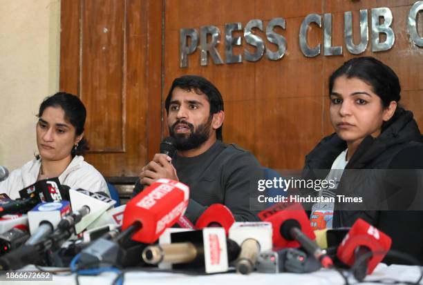 Wrestlers Vinesh Phogat , Bajrang Punia and Sakshi Malik during a press conference at Press Club of India on December 21, 2023 in New Delhi, India....