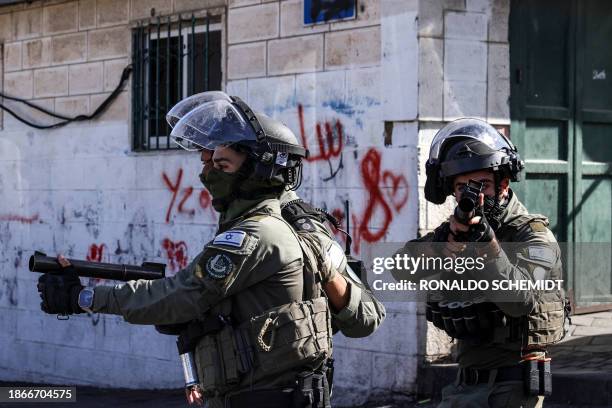 Israeli security forces fire tear gas during clashes in the Wadi Joz neighbourhood of Israeli-annexed east Jerusalem on December 22 amid the ongoing...