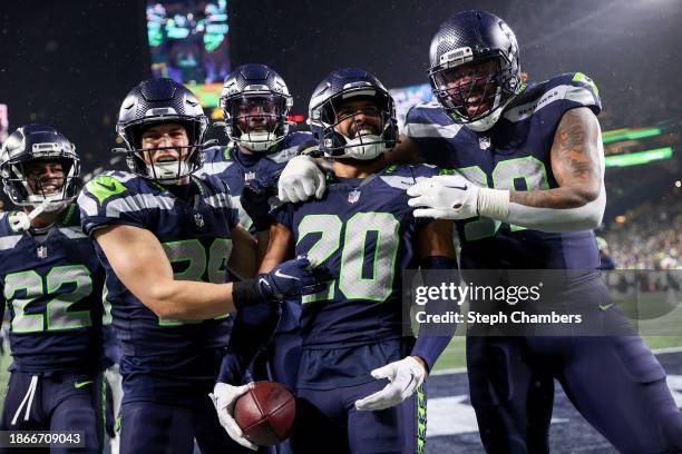 Julian Love of the Seattle Seahawks celebrates with teammates after an interception in the fourth quarter at Lumen Field on December 18, 2023 in...