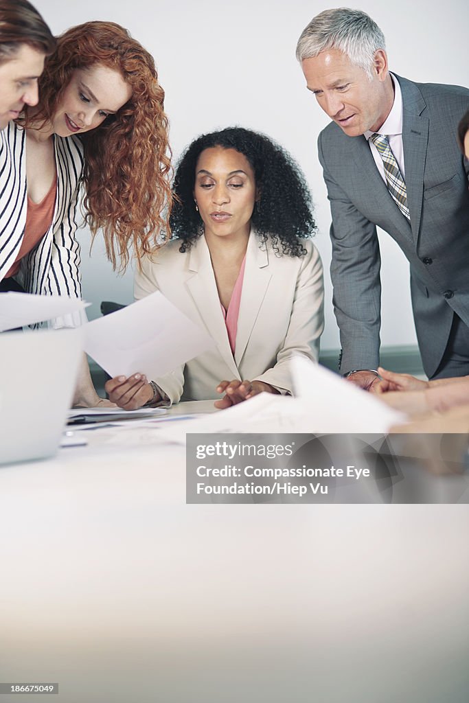 Business people looking at papers