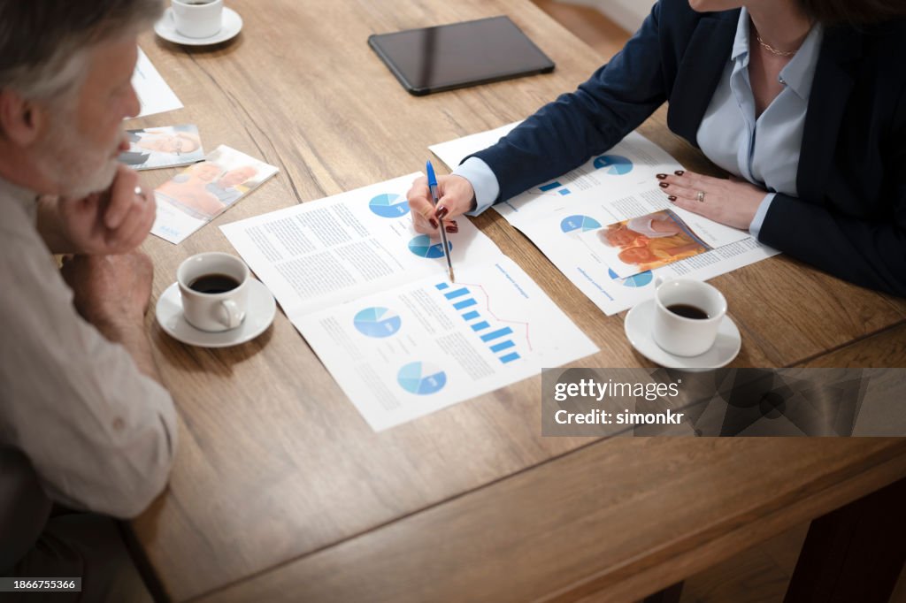 Financial advisor explaining document to man