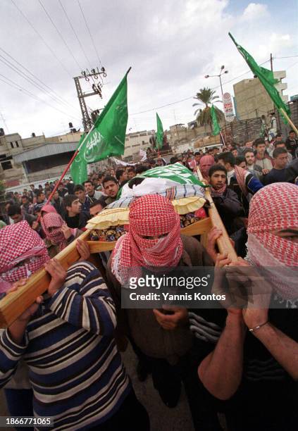 Palestinian members and supporters of Hamas carry the body of 20-year-old Mohammed Selmi during his funeral. Selmi, identified as a Hamas activist,...