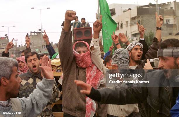 Palestinian members and supporters of Hamas carry the body of 20-year-old Mohammed Selmi during his funeral. Selmi, identified as a Hamas activist,...