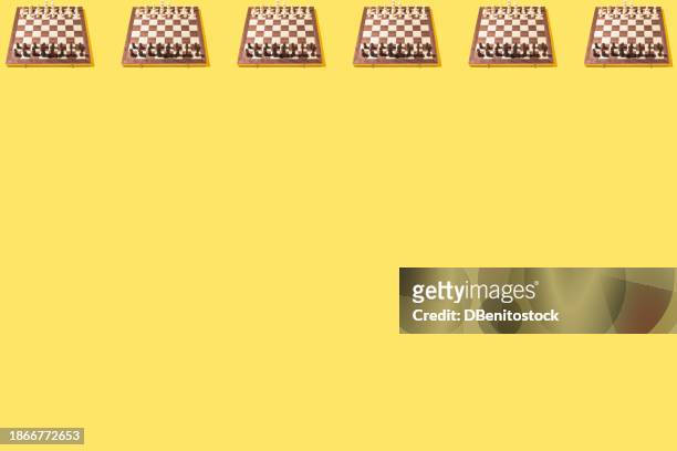 pattern of classic wooden chess boards with all the pieces placed, on top, on yellow background. concept of game, sport, battle, pawn, rook, bishop, knight, queen and king. - rook chess piece stock pictures, royalty-free photos & images