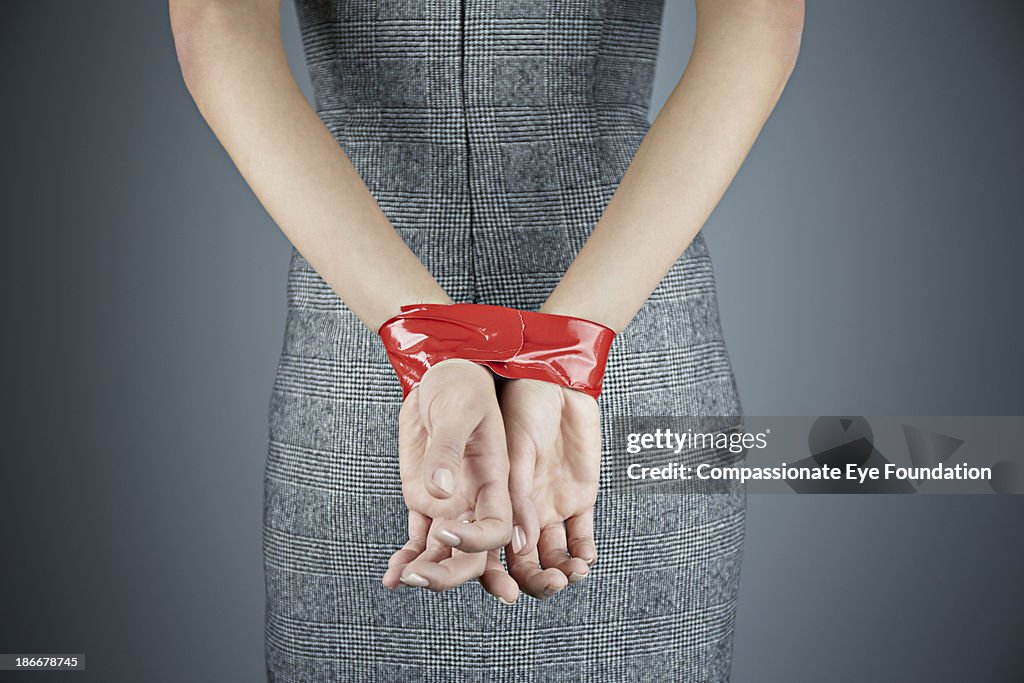 Woman with hands tied behind back