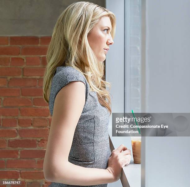 woman looking out of office window - womens indoor cup 2013 stock pictures, royalty-free photos & images
