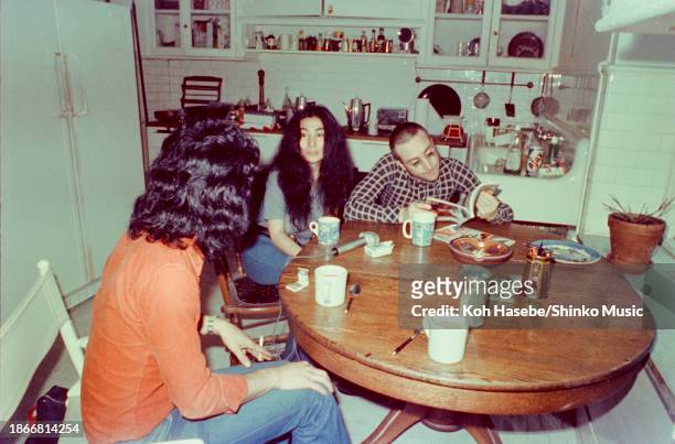 Artist Yoko Ono is interviewed by journalist Nobuyuki Yoshinari, with singer and musician John Lennon by her side reading a magazine, at their...