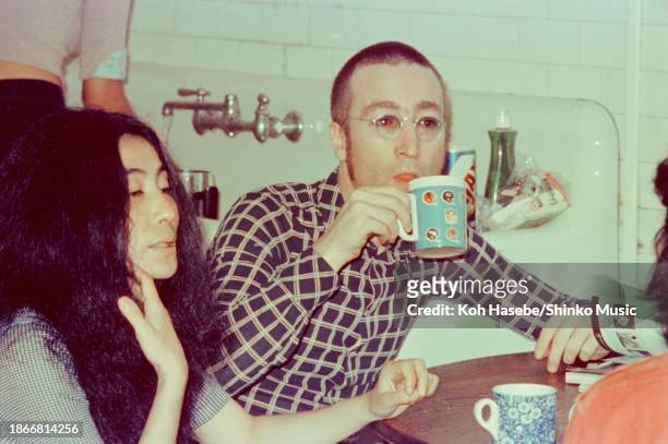 Artist Yoko Ono is interviewed by journalist Nobuyuki Yoshinari , with singer and musician John Lennon by her side drinking a cup of tea, at their...