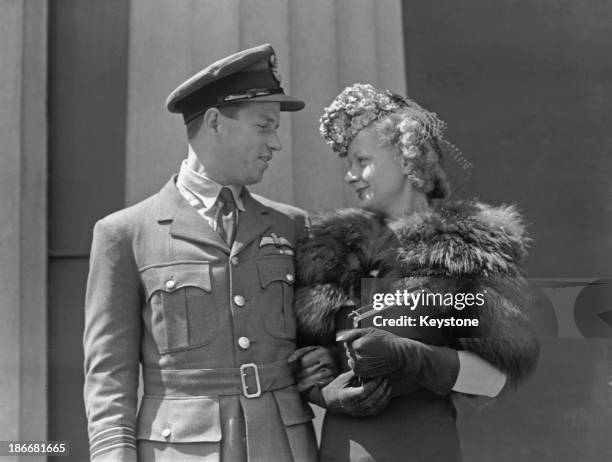 Royal Air Force Wing Commander Guy Gibson and his wife Eve after his investiture at Buckingham Palace, London, 22nd June 1943.