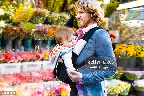 Father walking through city with baby