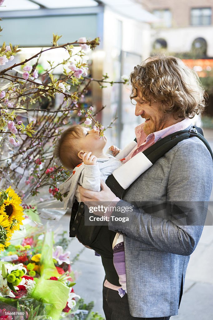 Father and baby shopping for flowers