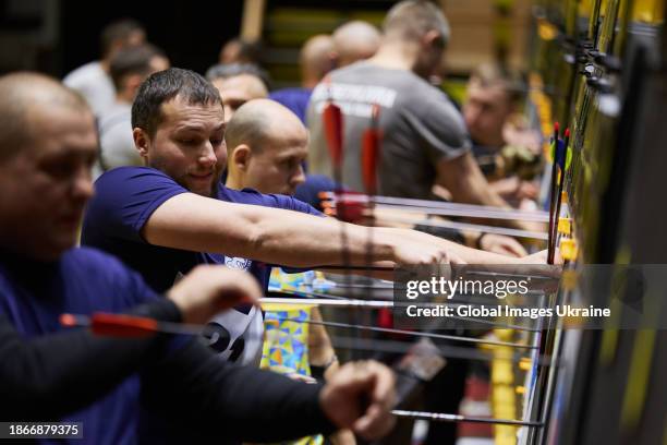 Ukrainian Invictus athlete takes arrows from the target in the qualifying competition in target archery for the United Air Force Trials 2024 on...