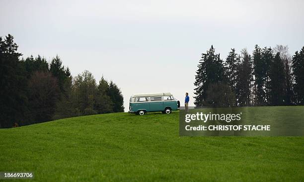 Volkswagen Kombi owner Wanja Fuhrmann poses in front of his Volkswagen T2 camper van built in the year 1975 near Landsberg, southern Germany, on...