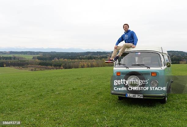 Volkswagen Kombi owner Wanja Fuhrmann poses on his Volkswagen T2 camper van built in the year 1975 near Landsberg, southern Germany, on November 1,...