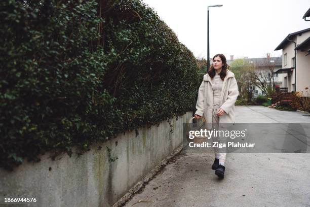 woman arriving home with the groceries for season holidays, using sustainable way of shopping bag, basket. no plastic bags. - backless dress stock pictures, royalty-free photos & images