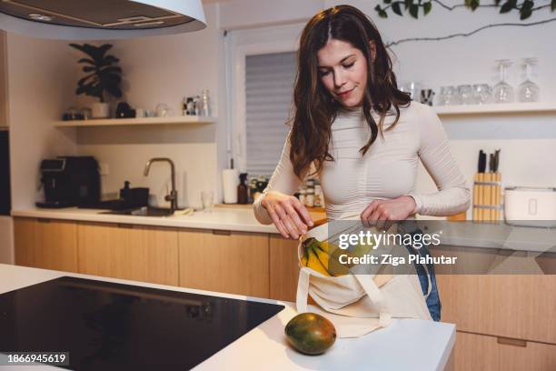 woman arriving home with the groceries for season holidays, using sustainable way of shopping bag, basket. no plastic bags. - backless dress stock pictures, royalty-free photos & images