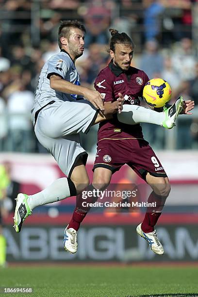 Paulinho of AS Livorno Calcio battles for the ball with Michele Canini of Atalanta BC during the Serie A match between AS Livorno Calcio and Atalanta...