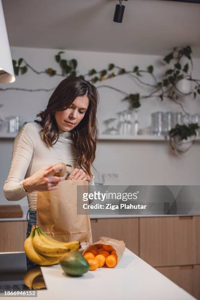 woman arriving home with the groceries for season holidays, using sustainable way of shopping bag, basket. no plastic bags. - backless dress stock pictures, royalty-free photos & images