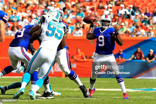 Thad Lewis of the Buffalo Bills throws the ball under pressure from Dion Jordan of the Miami Dolphins at Sun Life Stadium on October 20, 2013 in...