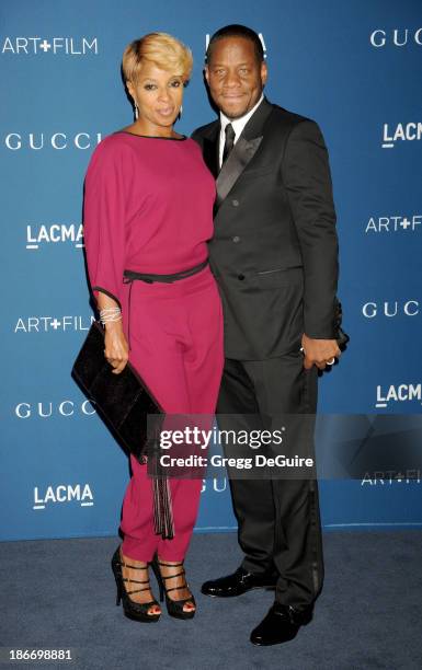 Singer Mary J. Blige and husband Kendu Isaacs arrive at the LACMA 2013 Art + Film Gala at LACMA on November 2, 2013 in Los Angeles, California.