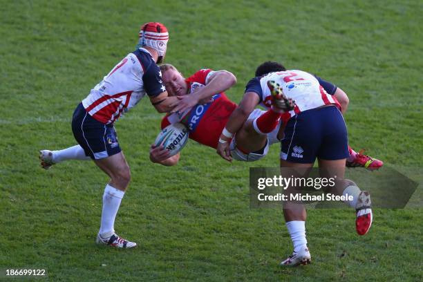 Christiaan Roets of Wales is upended by Craig Priestly and Bureta Faraimo of USA during the Rugby League World Cup Group D match between Wales and...