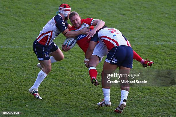 Christiaan Roets of Wales is upended by Craig Priestly and Bureta Faraimo of USA during the Rugby League World Cup Group D match between Wales and...