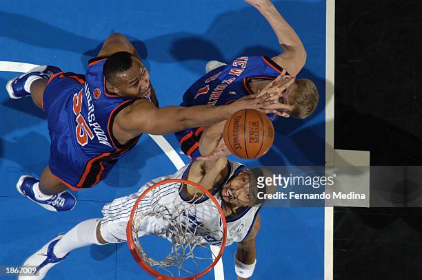 Drew Gooden of the Orlando Magic rebounds against Clarence Weatherspoon of the New York Knicks during the NBA game against the New York Knicks at TD...