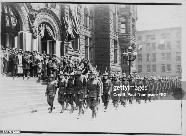 Soldiers of the 363rd US Regiment during World War One, marching past City Hall, Toronto, Canada, circa 1914-1918.