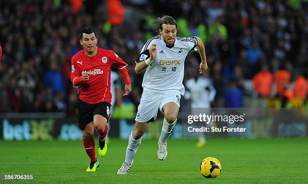 Swansea City player Michu outpaces Cardiff player Gary Medel during the Barclays Premier League match between Cardiff City and Swansea at Cardiff...
