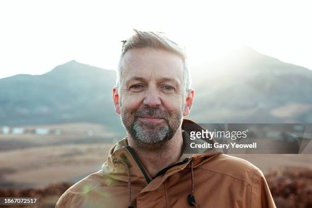 portrait of a mature male hiker in the landscape - confidence male landscape stock-fotos und bilder
