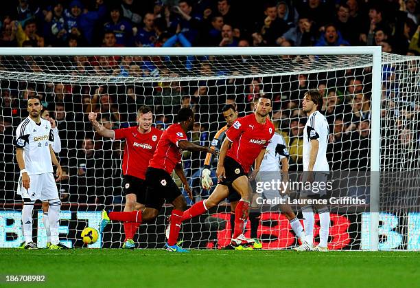 Despair for Swansea City as Steven Caulker of Cardiff City celebrates scoring their first goal during the Barclays Premier League match between...