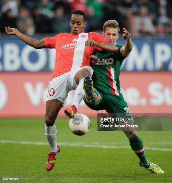 Andre Hahn of FC Augsburg is challenged by Junior Diaz of FSV Mainz during the Bundesliga match between FC Augsburg v 1. And FSV Mainz 05 at SGL...