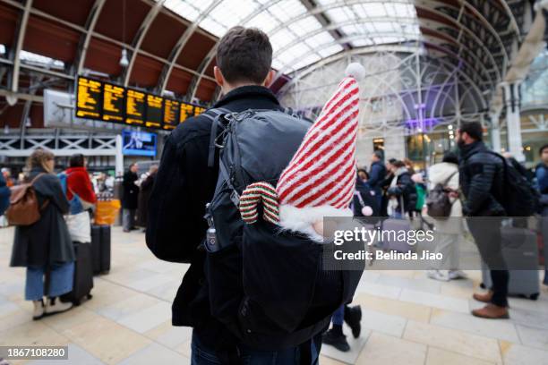 Passengers wait for their trains at Paddington Station on December 22, 2023 in London, England. Travel disruptions persist since Storm Pia hit the UK...