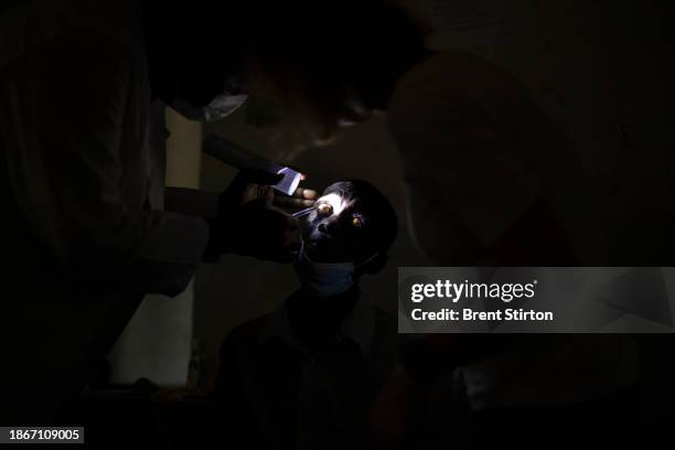 Man suffering from river blindness is examined by DNDI personel at a rural clinic. If peop,e are found to be positive, they are given Ivermectin for...