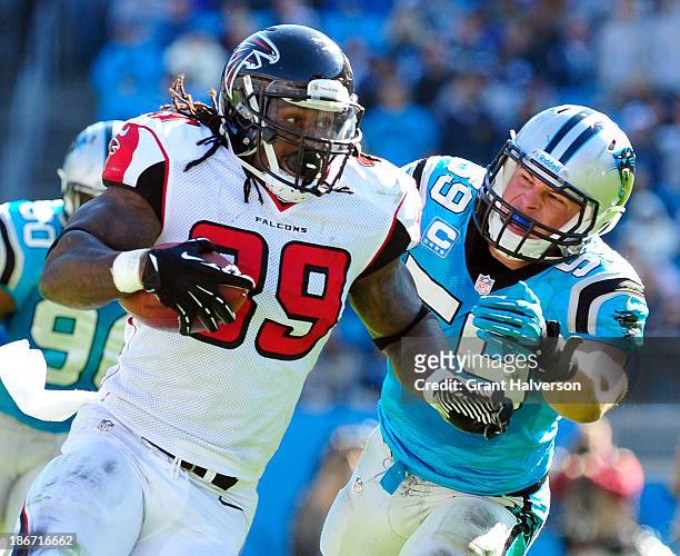 Luke Kuechly of the Carolina Panthers pursues Steven Jackson of the Atlanta Falcons during play at Bank of America Stadium on November 3, 2013 in...