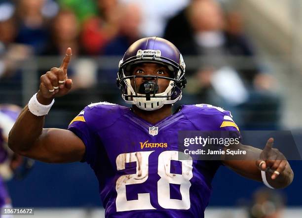 Running back Adrian Peterson of the Minnesota Vikings celebrates after a touchdown during the game against the Dallas Cowboys at Cowboys Stadium on...