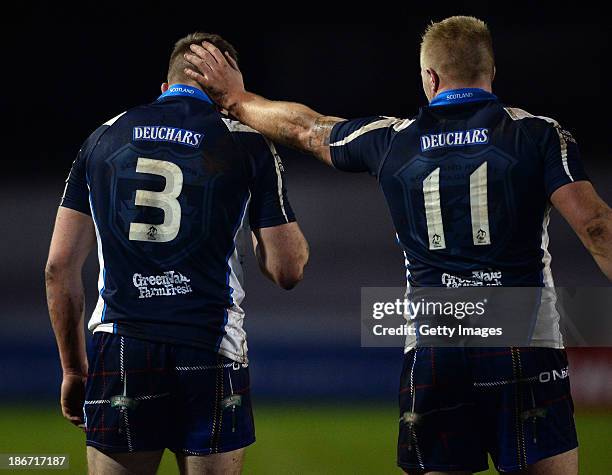 Ben Hellewell of Scotland receives congratulations from team mate Danny Addy after scoring the last try of the match to level the scores at 30-30...