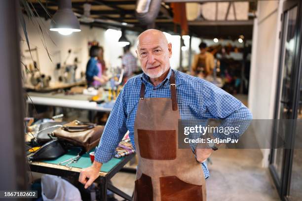 portrait of an senior caucasian male tailor and the owner of an leather workshop - working seniors stock pictures, royalty-free photos & images