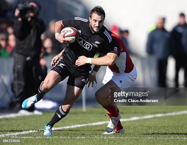 Andre Taylor of the New Zealand Maori All Blacks breaks a tackle against Team Canada during the AIG Canada friendly game at BMO Field on November 3,...
