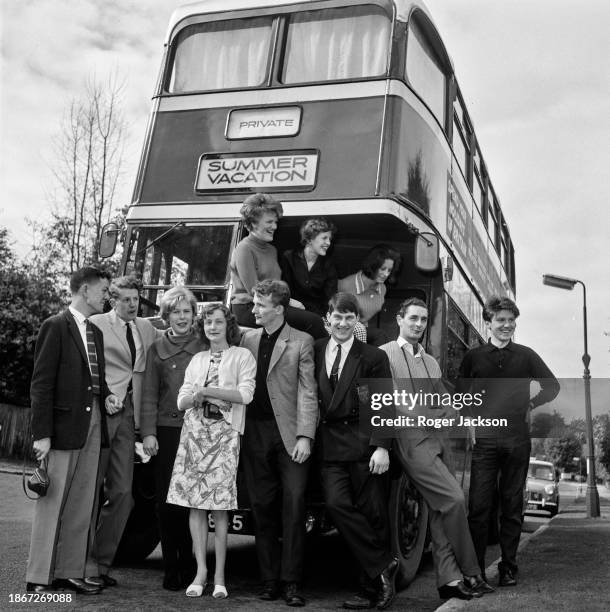 Party of eleven people with the double-decker bus they will use for their summer holiday, in Surbiton, Greater London, England, 31st August 1963....
