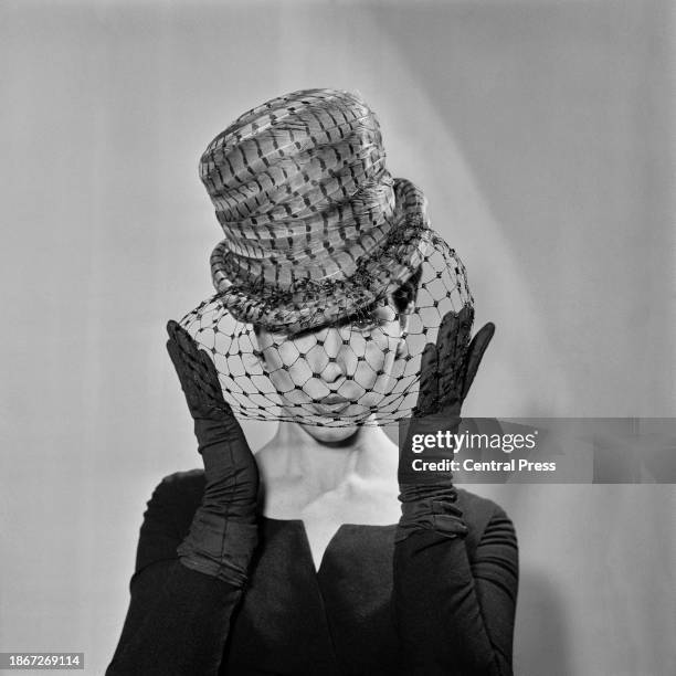 Model Isabel Babianska wearing a Regency topper made of pheasant tail feathers and a chicken wire veil, designed by milliner Gina Davies as part of...