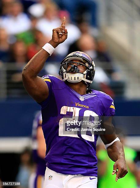 Running back Adrian Peterson of the Minnesota Vikings celebrates after a touchdown during the game against the Dallas Cowboys at Cowboys Stadium on...