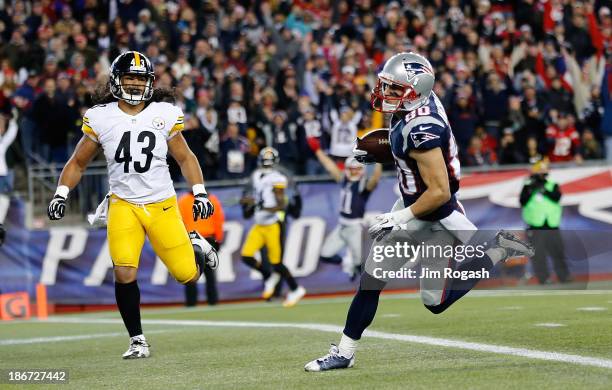 Danny Amendola of the New England Patriots scores a touchdown by Troy Polamalu of the Pittsburgh Steelers in the first quarter during a game at...