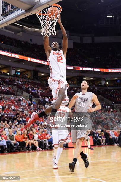 Sam Thompson of the Ohio State Buckeyes dunks in the first half as Hrvoje Vucic of the Walsh Cavaliers watches on November 3, 2013 at Value City...