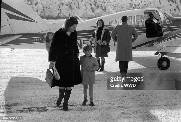 Jackie Kennedy with Caroline and John Jr. Getting off a plane during a skiing trip to Sun Valley, ID