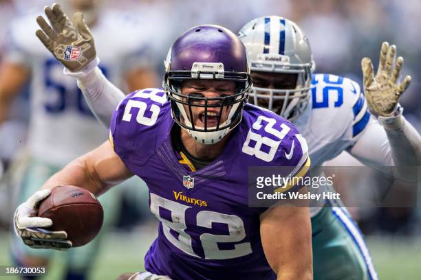 Kyle Rudolph of the Minnesota Vikings scores a touchdown against the Dallas Cowboys at AT&T Stadium on November 3, 2013 in Arlington, Texas. The...